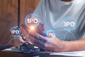 IPO hologram and a woman signing contract use phone. Double exposure. Initial primary offering concept.