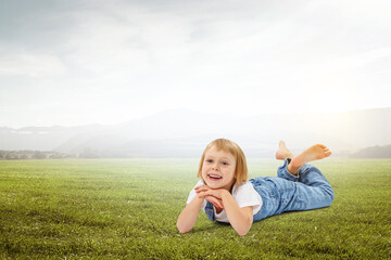 Fototapeta premium Little girl on the green grass