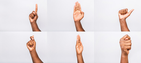 Fototapeta premium Afro-American black man's hand showing different gestures on white background, closeup view of hands.