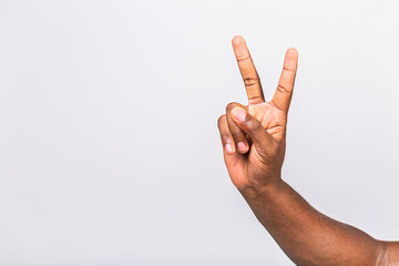 Afro-American black man's hand showing different gestures on white background, closeup view of hands.