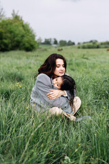 Vacation, wanderlust, travelling. Woman with daughter on green grass. Family, love, trust. Mothers day concept friend