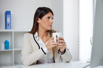 businesswoman drink a cup of tea at home office