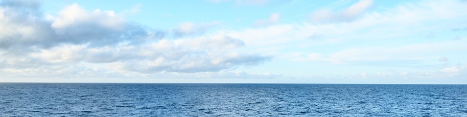 Panoramic view of the open Baltic sea with beautiful glowing sunset clouds in a clear blue sky....
