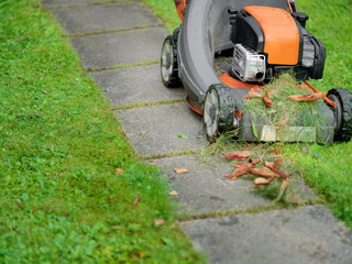 Fototapeta premium lawn mower next to a footpath