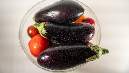 Eggplants and tomatoes in a salad bowl	