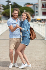 happy loving couple posing on a pier