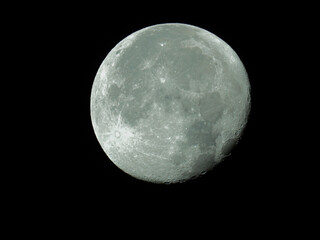  big waning moon with its moon craters in the black night sky