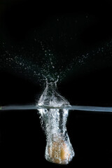 Onion immersed in water, on black background	