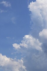 White cumulus clouds in blue sky