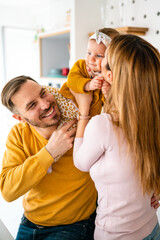 Smiling young parents and their child are very happy