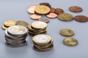 stacked euro coins and jumpled cents
