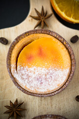 Obraz na płótnie Canvas Orange grated cake with powdered sugar