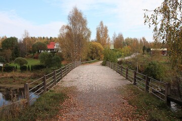 An old bridge in the countryside in the autumn. The bridge is Tönnö Museum bridge, which is the oldest reninforced concrete road bridge in Finland. The bridge was built in 1911.