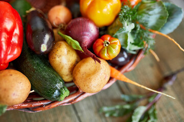Assortment of fresh vegetables in a basket, bio healthy, organic food on wooden background, country...