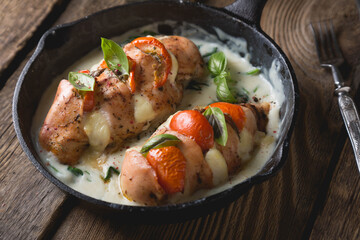 Chicken fillet baked with mozzarella tomatoes and basil