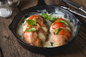 Chicken fillet baked with mozzarella tomatoes and basil