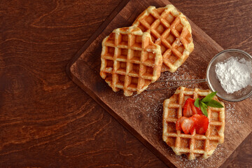 fresh hot belgian waffles on cutting board