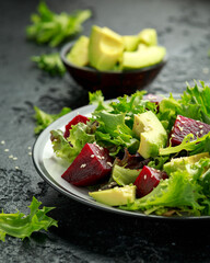 Vegetarian avocado and beet salad in plate. Healthy vegan food