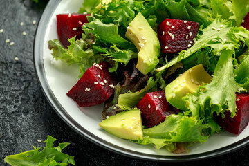 Vegetarian avocado and beet salad in plate. Healthy vegan food
