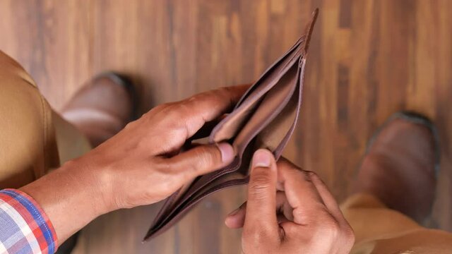 Man hand open an empty wallet with copy space.