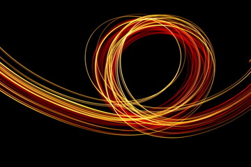 Long exposure photograph of neon red and gold colour in an abstract swirl, parallel lines pattern...