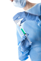 surgical nurse preparing injection in blue scrubs
