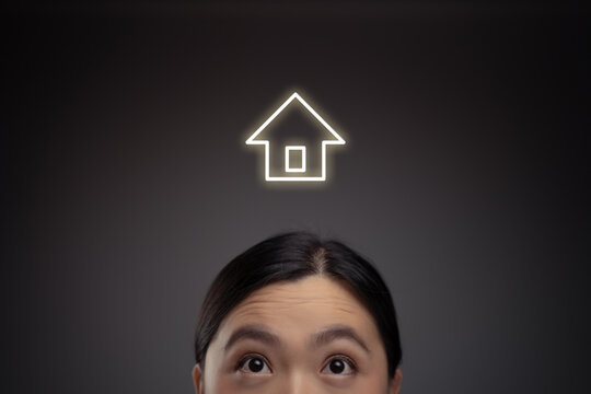 Happy Asian woman and home icon hologram effect.