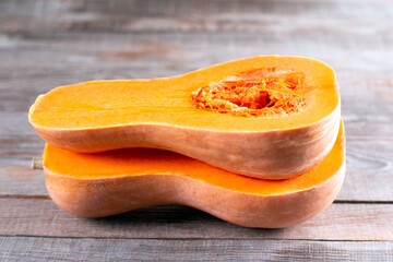 Butternut squash sliced in half. Sliced butternut squash over wood background.