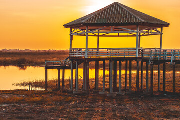 Dry or arid lake and old vintage pavilion with sunset light on the evening.