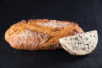 Rustic bread with golden crust and half of cheese	
