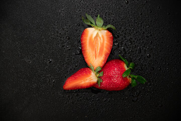 Ripe strawberries on a black background	