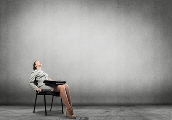 Emotional businesswoman in chair