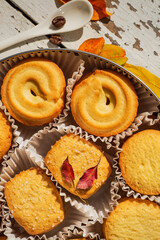 Cookies, blancket and autumn leaves. Background, biscuit.