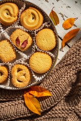 Obraz na płótnie Canvas Cookies, blancket and autumn leaves. Background, biscuit.