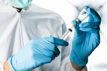 Doctor, nurse, scientist or researcher  holding coronavirus (covid-19) vaccine for clinical trials in human