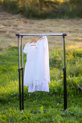 Linen dresses hanging on a hanger outdoors