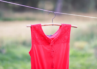 Linen dress hanging on a hanger outdoors