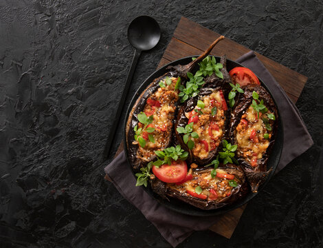 Karniyarik. Stuffed eggplant, eggplant with meat and vegetables, baked with tomato sauce, Turkish cuisine. Top view, close-up. Copy space