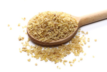 Dry bulgur in wooden spoon isolated on white background