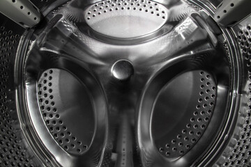Inside the drum of an old washing machine. Scratches on the drum of a broken washing machine....