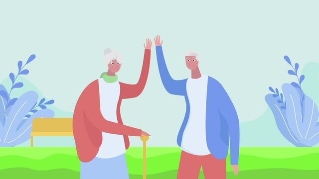 Old couple making high five gesture at the park