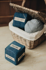 Jeans textile bloom cube for kids, teenagers, adults reflection, game and learning and wicker basket with cubes and other learning materials from jeans on the background