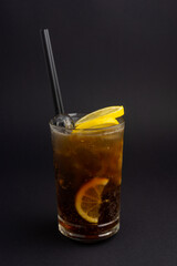 Long Island Ice Tea cocktail on black .background