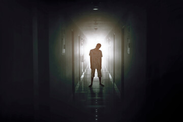 Bloody male zombie walking in the hotel corridor