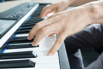 Fototapeta na wymiar Pianist playing electronic piano close up