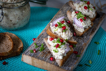 Farshmak with butter and bread. On a wooden table.