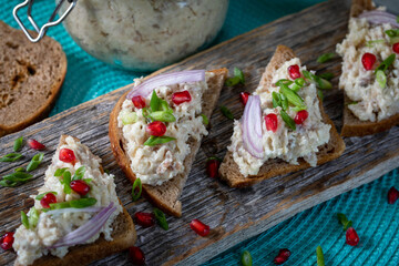 Farshmak with butter and bread. On a wooden table.