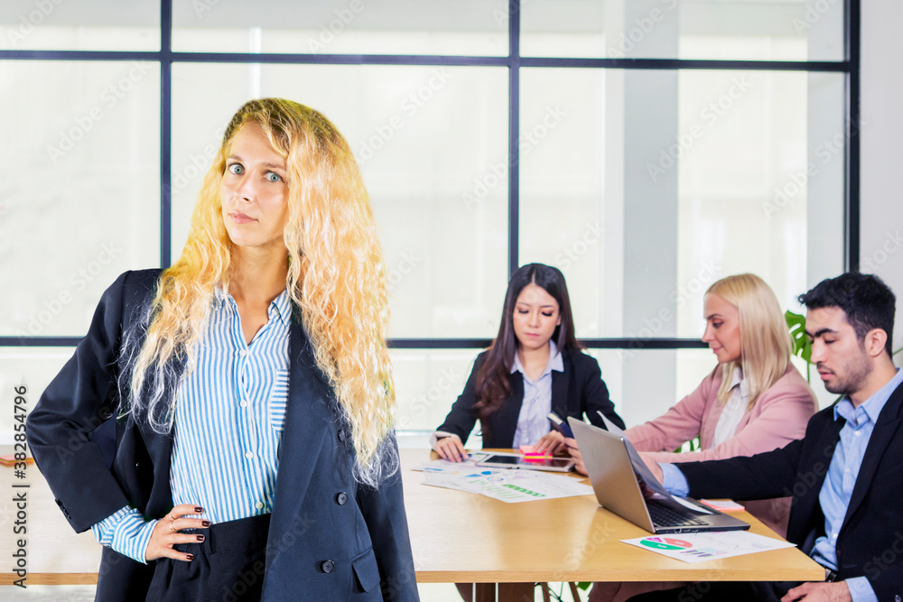 Poster Confident blonde businesswoman with her employees