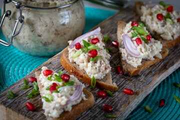 Farshmak with butter and bread. On a wooden table.