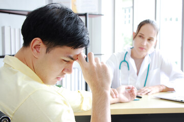 Fototapeta premium Professional Caucasian Female Psychiatrist (MD) is counseling and treament asian man. Male is headache and Migraine. Major depressive disorder patients and healthcare Concept.